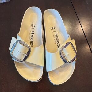 Birkenstock large buckle patent cream is on the yellow end